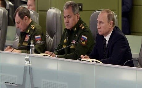 Russian Defence Minister Sergei Shoigu (c) and Russian President Vladimir Putin (l) at the National Defence Control Centre of the Russian Federation in Moscow on November 17, 2015. Photo: Alexei Nikolsky/AFP