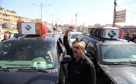 A funeral procession for protesters killed in Baghdad violence. AP photo.