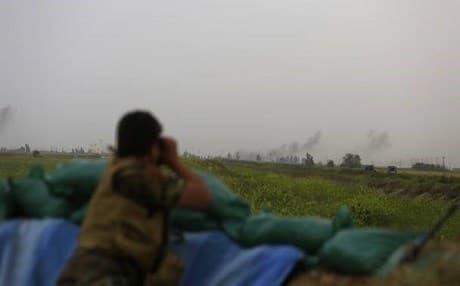 A Syrian rebel looking through his binoculars on the Turkey-Syria border. AP photo