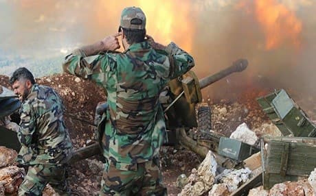Syrian soldiers firing at enemy positions. AP file photo. 
