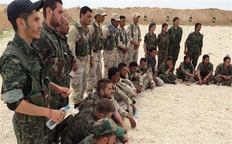  Fighters of the Syrian Democratic Forces (SDF) gather after a training session at a firing range in northern Syria. AP photo