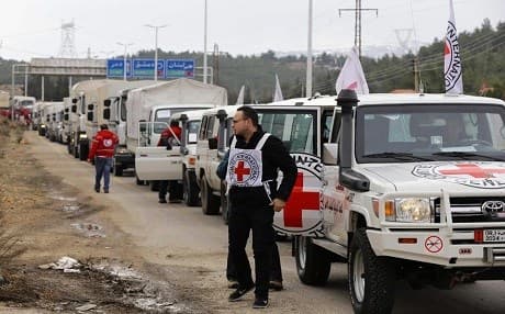Aid agencies have been able to deliver limited amounts of medicine and food aid to besieged areas of Syria via ground deliveries. In this image, a Red Cross convoy waits outside the city of Madaya in January. Photo: Louai Beshara/AFP