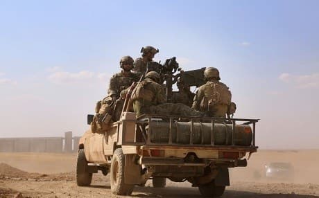 U.S. Special Operations forces ride in the back of a pickup truck in the village of Fatisah in the northern Syrian province of Raqqa on May 25. (Delil Souleiman/AFP/Getty Images)
