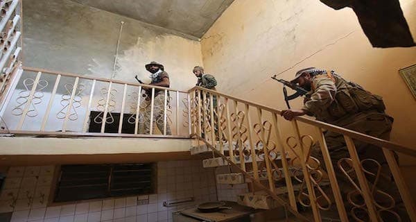 Members of the Shiite militia known as Hashd al-Shabi inside a house in the outskirts of Fallujah. AFP photo