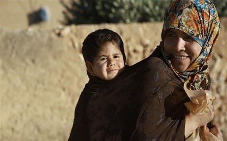 A Syrian women carrying her child in the northern Syrian town of Manbij. Photo: AFP
