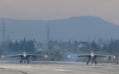 Two Russian Sukhoi SU-25 bombers are pictured at the Hmeimim military base in Syria on December 16, 2015. Photo: Paul Gypteau/AFP