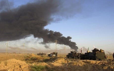 Smoke rises from Islamic State positions after an airstrike by coalition warplanes in Fallujah. AP file photo  