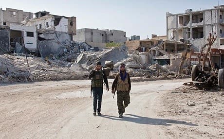 Kurdish forces patrol the streets of Kobane. Photo: AP
