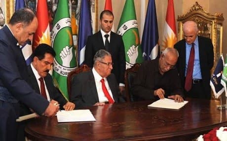 PUK and Gorran officials while signing a historic agreement in Sulaimani, with PUK leader Jalal Talabani seated in between, May, 2016. Rudaw photo.