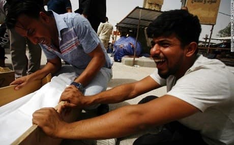 Iraqis grieve the loss of five family members in a suicide bombing in Baghdad. Photo: Haidar Hamdani/AFP/Getty Images