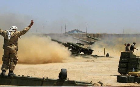Iraqi troops and their Shiite militia partners fire artillery into the city of Fallujah during their military operation in June. AFP photo