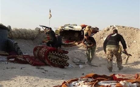 Iraqi security forces defend their positions against an Islamic State attack in the Anbar province. AP file photo