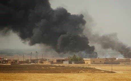 Smoke rises during a military operation launched by Peshmerga focres to regain control of a village from the hands of Islamic State (ISIS) in the oil-rich city of Kirkuk. Photo: AP
