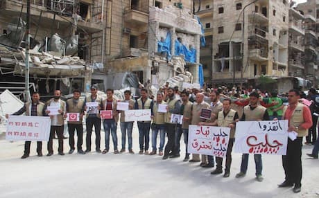 Syrian activists holding Arabic placards that read, "Save Aleppo, Aleppo burned, Aleppo is being wiped out," during a sit-in in Aleppo, Syria. AP photo
