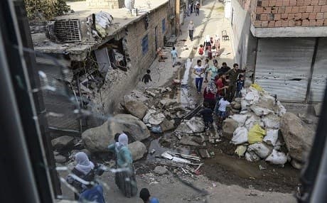 Residents gather to see the damage in Cizre after a curfew was lifted in September 2015. Photo: Ilyas Akengin/AFP