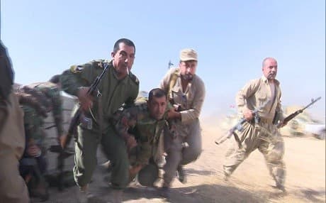 Kurdish Peshmerga carrying away a wounded fellow soldier during battle with Islamic State (ISIS) militants. Photo: Rudaw