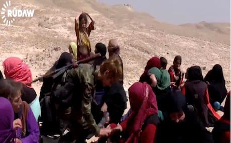A Peshmerga soldier feeding IDPs fleeing Hawija, southern Kirkuk. File photo from Rudaw video