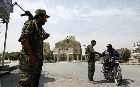 Kurdish Asayesh investigate a motorcyclist in the al-Masaken neighbourhood of Hasakah. Photo: Delil Souleiman/AFP