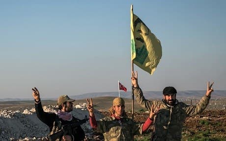 Syrian Kurdish Peoples Protection Units (YPG) fighters on the Syrian border with Turkey. AP file photo. 