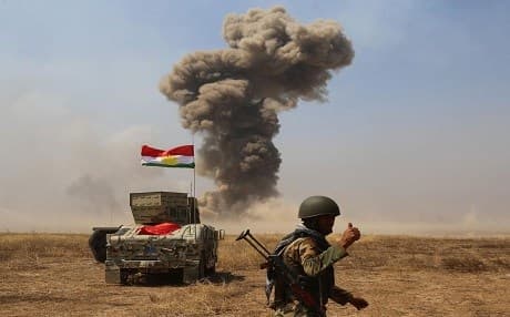 Smoke rises in the distance after Coalition forces bomb ISIS targets Mosul's Hazer region last May. Photo: AA.
