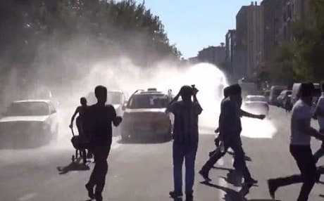 Turkish security forces used water cannons against people protesting the mayors' suspensions in Diyarbakir on Sunday. Photo: Ruptly video