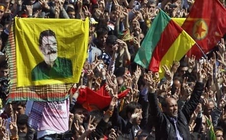 PKK supporters in Turkey's southeastern city of Diyarbakir hold banner of Abdullah Ocalan during a 2013 demonstration. AP file photo. 