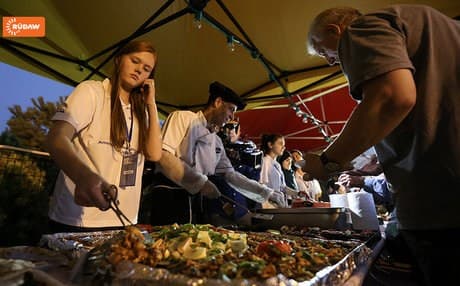Volunteers wait to dish out for a good cause at the food festival.