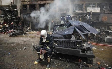 An Iraqi fireman rests after putting out a fire from a car bombing in Baghdad last June. AFP file photo.
