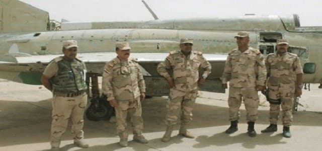 Iraqi commanders pose next to a derelict MiG-21 at the Qayyara airbase after its recapture in July. Photo: Iraqi Ministry of Defence.