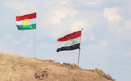 Kurdish and Iraqi flags fly side-by-side at the Makhmour front, south of Erbil. Photo: Farzin Hassan/Rudaw.