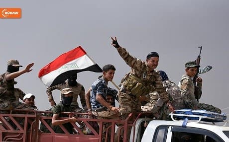 Iraqi soldiers driving through the town of Qayyara upon its liberation from ISIS in late August.