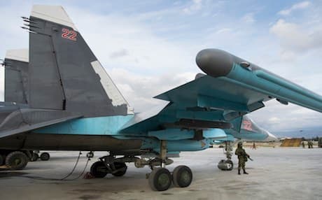 A Russian soldier stands guard next to a Su-34 bomber at Hmeymim  air base in Syria on Wednesday Jan. 20, 2016. AP file photo.