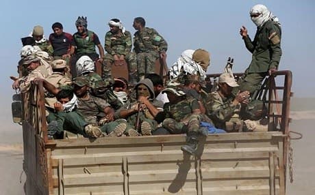 Iraqi Shiite militia forces heading to fight Islamic State (ISIS) militants in the Samarra desert earlier this year. AP file photo. 