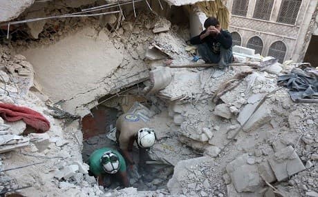 Syrian Civil Defense volunteers known as the White Helmets dig through the rubble after an airstrike in Bustan al-Basha, Aleppo on Tuesday. Photo: AFP