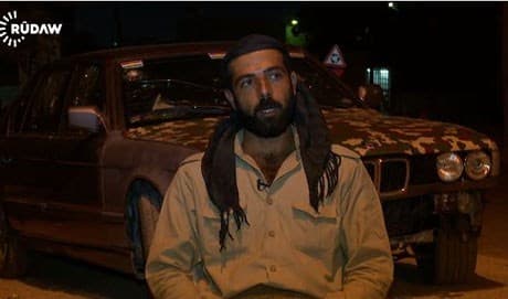 Ako Abdulrehman with his BMW car in the background. Rudaw photo