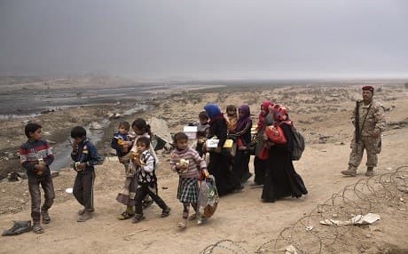 Displaced civilians near a checkpoint in Qayyara on Wednesday. Photo: Marko Drobnjakovic/AP