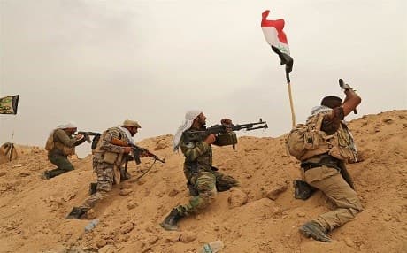 Hashd al-Shaabi fighters in clash with ISIS outside of Fallujah in June. AP file photo. 