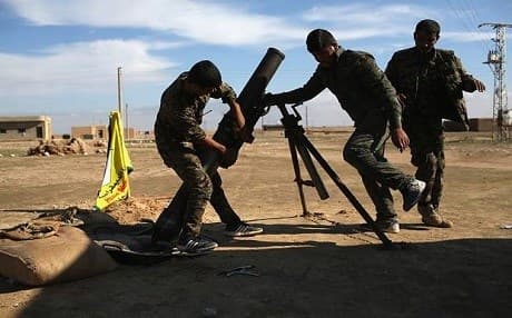 Syrian Democratic Forces (SDF) troops firing a mortar. Getty Images. 