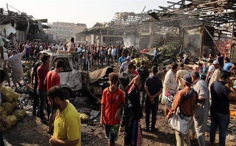 Civilians gather at the site of a bomb attack in Baghdad. Photo: AP