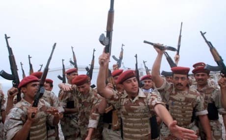 Iraqi soldiers celebrate the handover of a military base to them from British forces, 2007. Photo: AFP