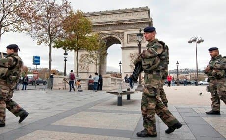 French soldiers patrol beside the Arc de Triomphe in Paris following last November's terrorist attack. AP file photo. 