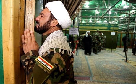 A militia fighter prays in a Shiite shrine in Samarra.  The predominantly Sunni city is home to some of the holiest sites of Shiite Islam. Two explosions in 2006 that targeted Samarra's Shiite shrine of  Imam al-Askari inflamed the sectarian conflict in Iraq. The attack was blamed on Sunni militia and Shiite militia retaliated. Photo: AFP