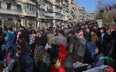 Civilians at a government-manned checkpoint in Maysalun, Aleppo on Thursday. Photo: AFP 