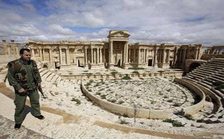 Syrian policeman in Palmyra's ancient Roman amphitheater before ISIS's May 2015 takeover. AFP file photo. 