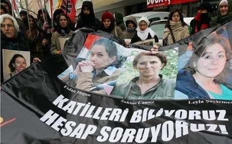 Supporters hold posters of the three PKK women killed in Paris. AFP photo