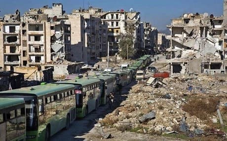A number of green buses in Aleppo transporting civilians and rebel  fighters out of Aleppo in December. Photo: AFP