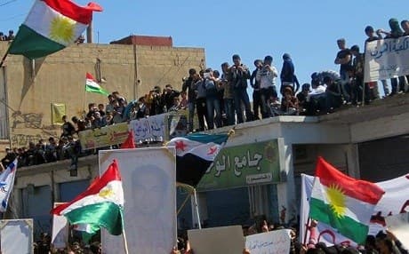 Kurdish people waving national flag gather in Qamishli city in northern Syria. AFP file photo