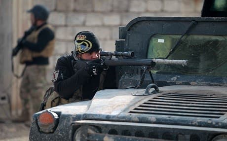 A member of the Iraqi forces aims his weapon as troops advance in Mosul. Photo:AFP