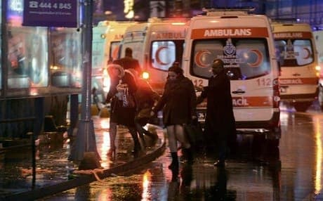 People leave as security officials work at the scene of an attack which targeted a  nightclub in Istanbul. Photo: AP 