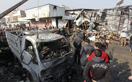 Iraqis inspect the site of an attack at Baghdad's main vegetable market. (AFP)